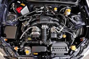 The flat four cylinder 2.0L engine carries both Subaru and Toyota insignias since Toyota offers the twin Scion FR-S.