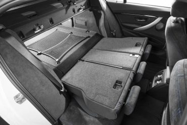 Even though the 330e is a hybrid, it's still highly functional with fold-down  rear seats and a large pass-through to the trunk.
